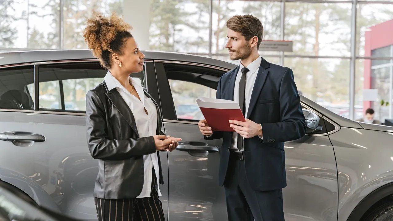 A sales consultant talking a customer through a new car